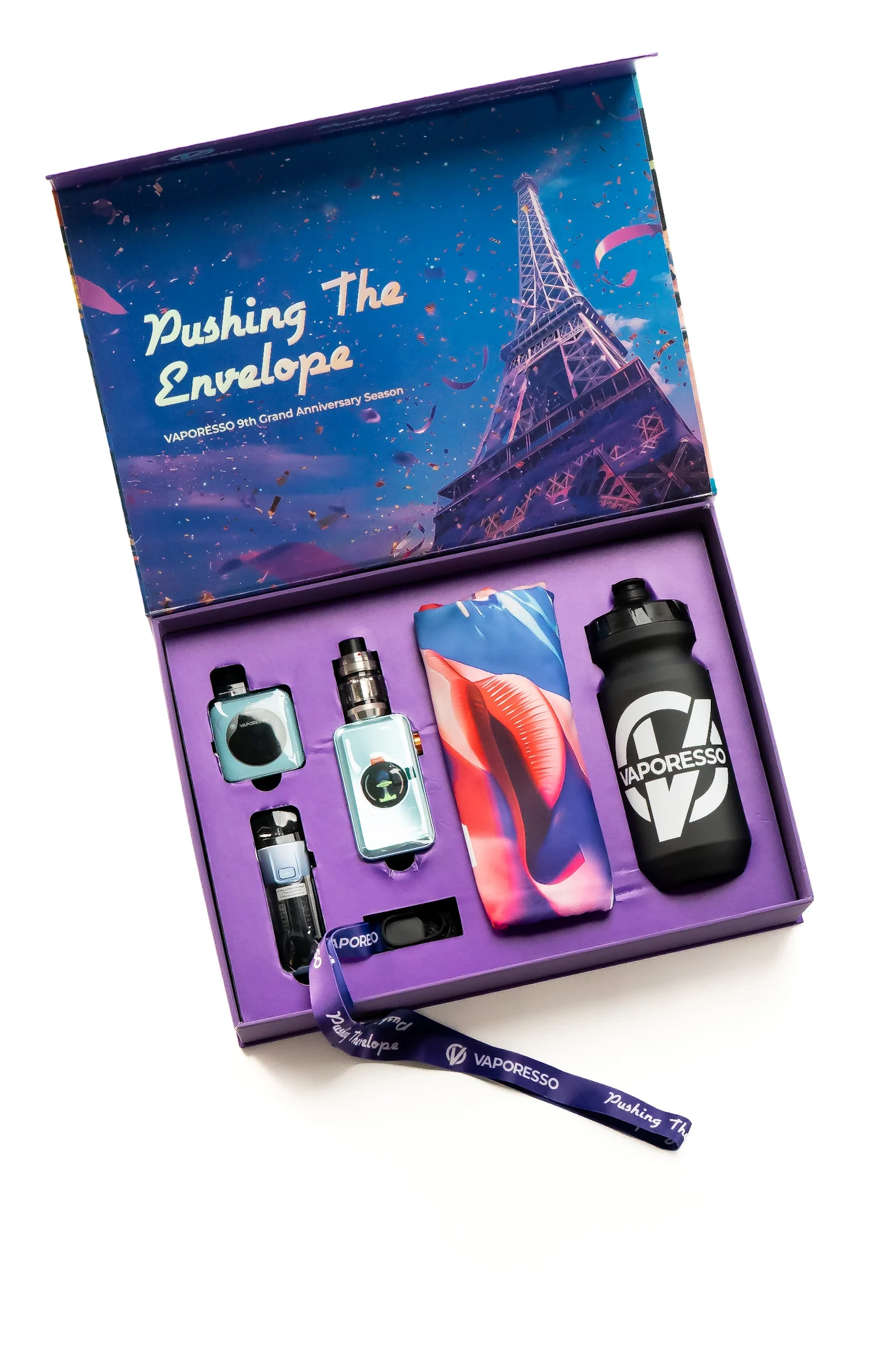 A colorful vape kit displayed in a purple box, featuring devices, a water bottle, and a lanyard, with Eiffel Tower backdrop.