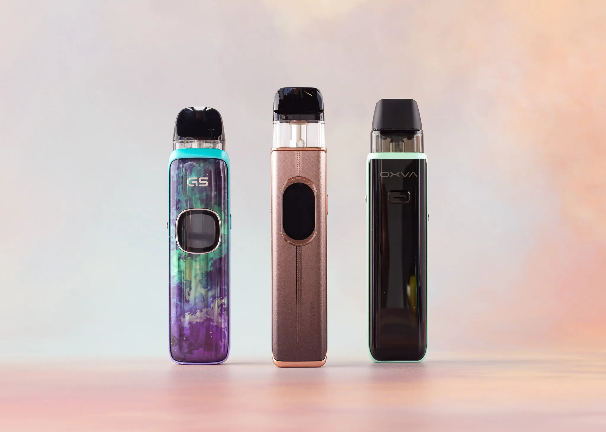 Three colorful pod kits displayed side by side against a soft, gradient background.